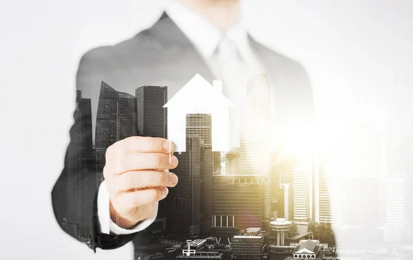 Close up of businessman holding paper house — Stock Photo, Image