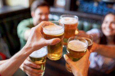 happy friends drinking beer at bar or pub