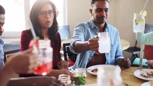 Friends eating and clinking glasses at restaurant — Stock Video