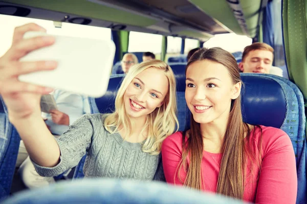 Women taking selfie by smartphone in travel bus — Stock Photo, Image