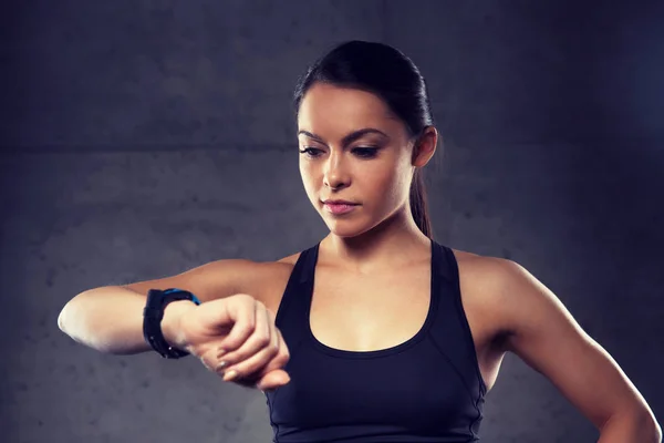 Młoda kobieta z tętna zegarek w siłowni — Zdjęcie stockowe