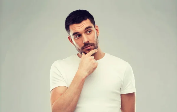 Man thinking over gray background — Stock Photo, Image