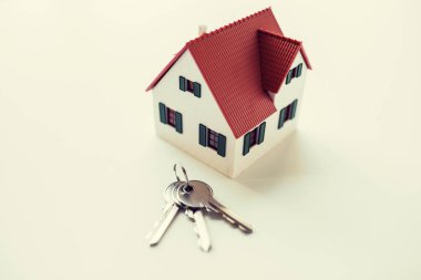 close up of home model and house keys clipart