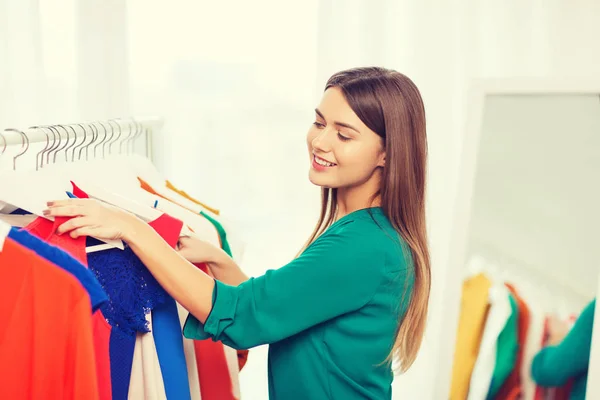 Happy woman choosing clothes at home wardrobe — Stock Photo, Image