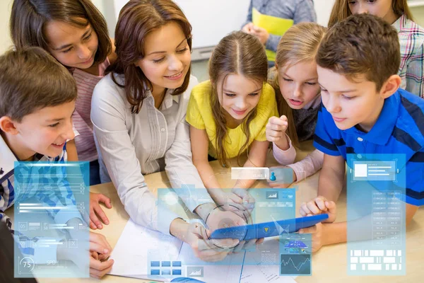 Groep van jonge geitjes met leraar en tablet pc op school — Stockfoto