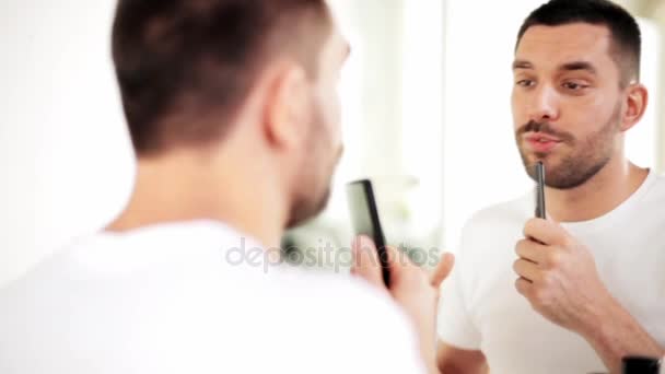 Homme avec peigne regardant au miroir et chantant — Video