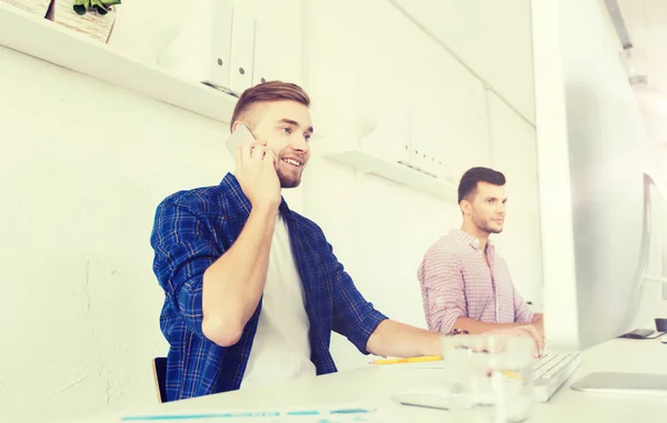 Gelukkig creatieve man roepen op mobiel op kantoor — Stockfoto