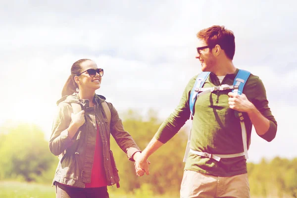 Happy couple with backpacks hiking outdoors — Stock Photo, Image