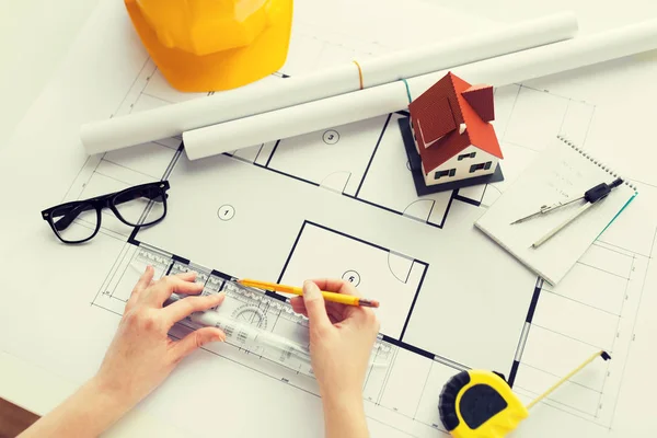 Close up of hands with ruler measuring blueprint — Stock Photo, Image