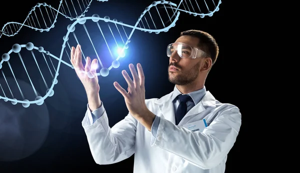 Scientist in lab coat and safety glasses with dna — Stock Photo, Image