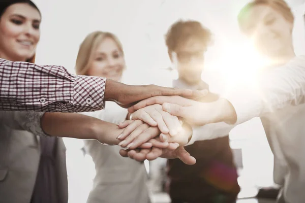 Happy business team with hands on top at office — Stock Photo, Image