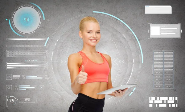 Sporty woman with tablet pc showing thumbs up — Stock Photo, Image