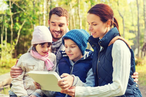 Happy family with tablet pc at camp — Stock Photo, Image