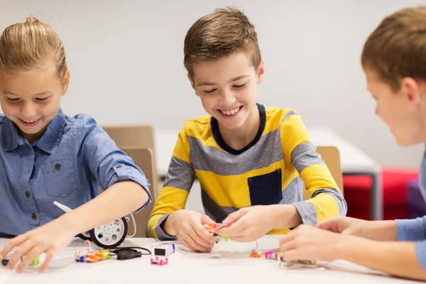 Gelukkige kinderen bouwen robots op robotica school — Stockfoto