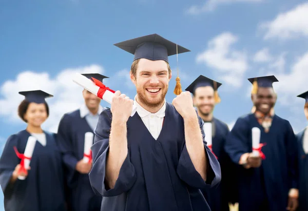 Happy student with diploma celebrating graduation — Stock Photo, Image