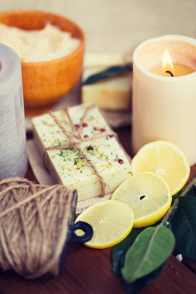 Close up of natural soap and candles on wood — Stock Photo, Image