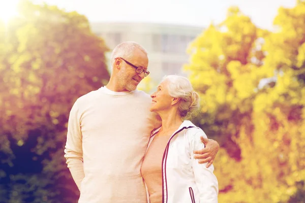 Senior couple hugging in city park — Stock Photo, Image