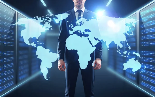 Businessman with world map projection in corridor — Stock Photo, Image