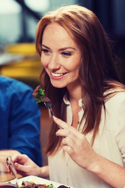 Happy woman having dinner at restaurant — Stock Photo, Image