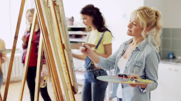 Estudiantes con caballetes pintando en la escuela de arte — Vídeo de stock