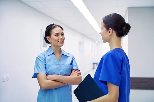 Medics, nurses or doctors talking at hospital — Stock Photo, Image