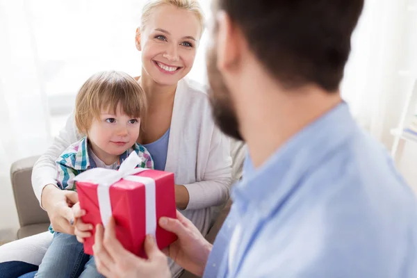 Happy family with birthday gift at home — Stock Photo, Image