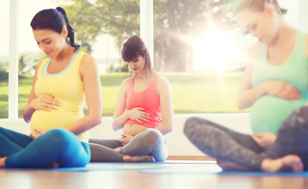 Happy pregnant women exercising yoga in gym — Stock Photo, Image