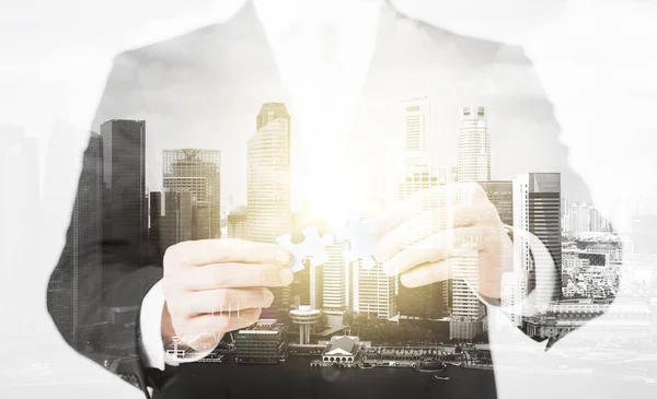 Close up of businessman with puzzle pieces — Stock Photo, Image