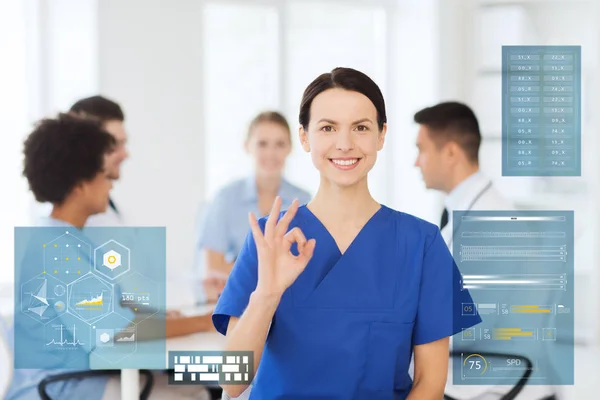 Happy doctor at hospital showing ok hand sign — Stock Photo, Image