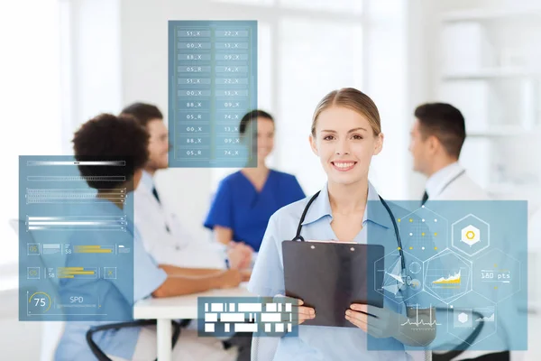 Happy doctor with clipboard at hospital — Stock Photo, Image