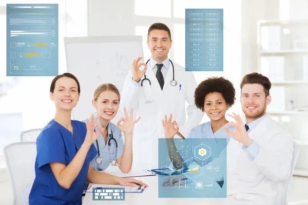 Group of doctors showing ok hand sign at hospital — Stock Photo, Image