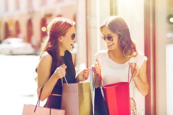 Mujeres felices con bolsas de compras en la ciudad — Foto de Stock
