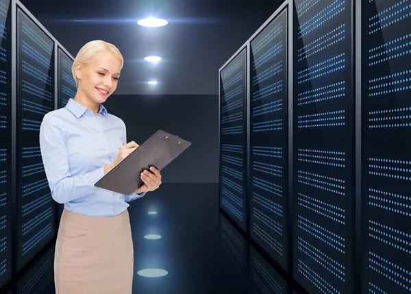 Businessman with clipboard over server room — Stock Photo, Image