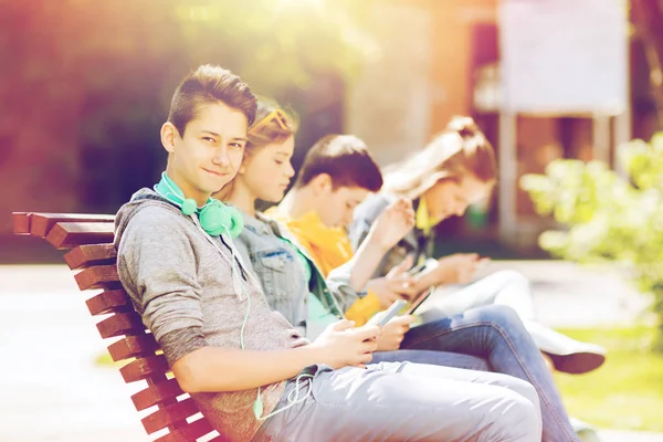 Happy teenage boy with tablet pc and headphones — Stock Photo, Image