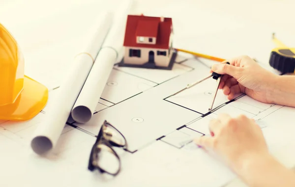 Close up of hands with compass measuring blueprint — Stock Photo, Image