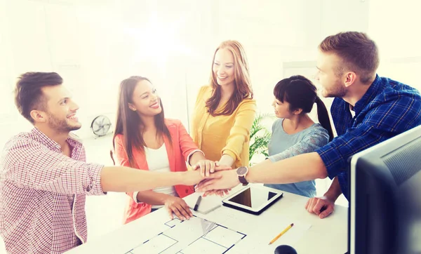 Creative team holding hands together  at office — Stock Photo, Image