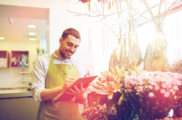 Florist man with clipboard at flower shop — Stock Photo, Image