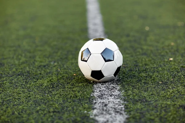 Bola de futebol na linha de marcação de campo de futebol — Fotografia de Stock