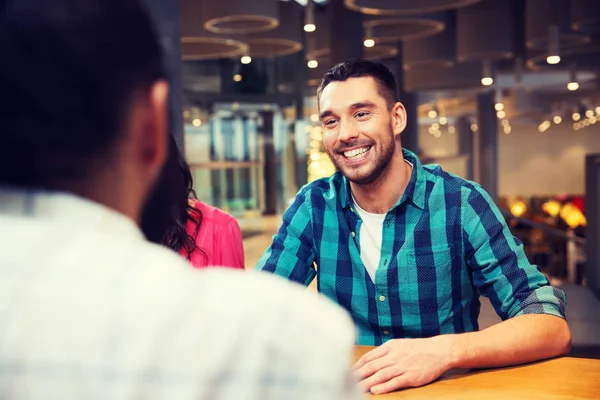 Happy man meeting with friends at restaurant — Stock Photo, Image