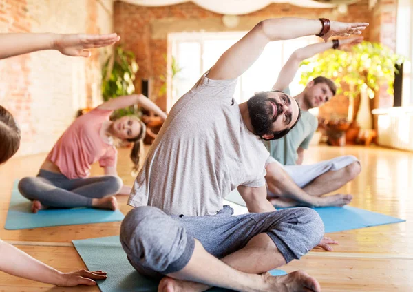 Group of people doing yoga exercises at studio — Stock Photo, Image