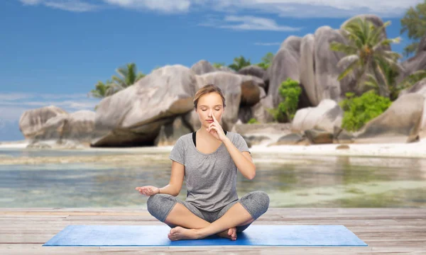 Vrouw doet yoga ademhaling oefening op strand — Stockfoto