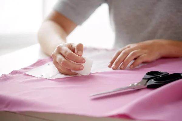 Woman with pattern and chalk drawing on fabric — Stock Photo, Image