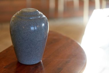 cremation urn on table in church clipart