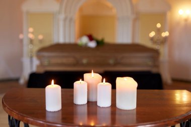 burning candles and coffin in church at funeral clipart