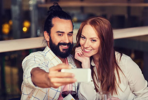 Couple taking selfie by smartphone at restaurant — Stock Photo, Image