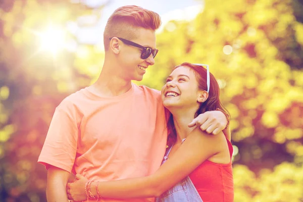 Happy teenage couple looking at each other in park — Stock Photo, Image