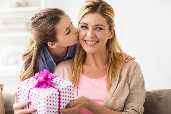 Chica dando regalo de cumpleaños a la madre en casa —  Fotos de Stock