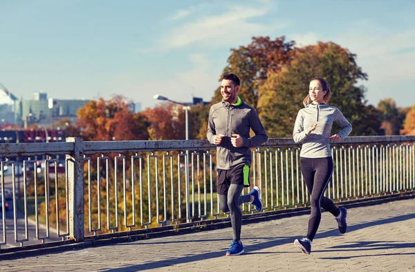 happy couple running outdoors