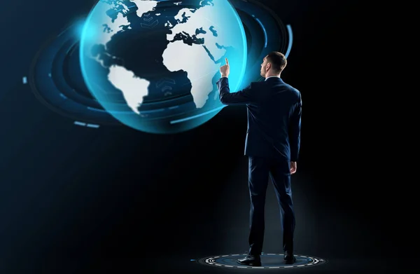 Businessman in suit touching earth globe hologram — Stock Photo, Image