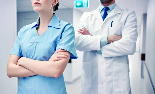 Close up of doctor and nurse at hospital corridor — Stock Photo, Image